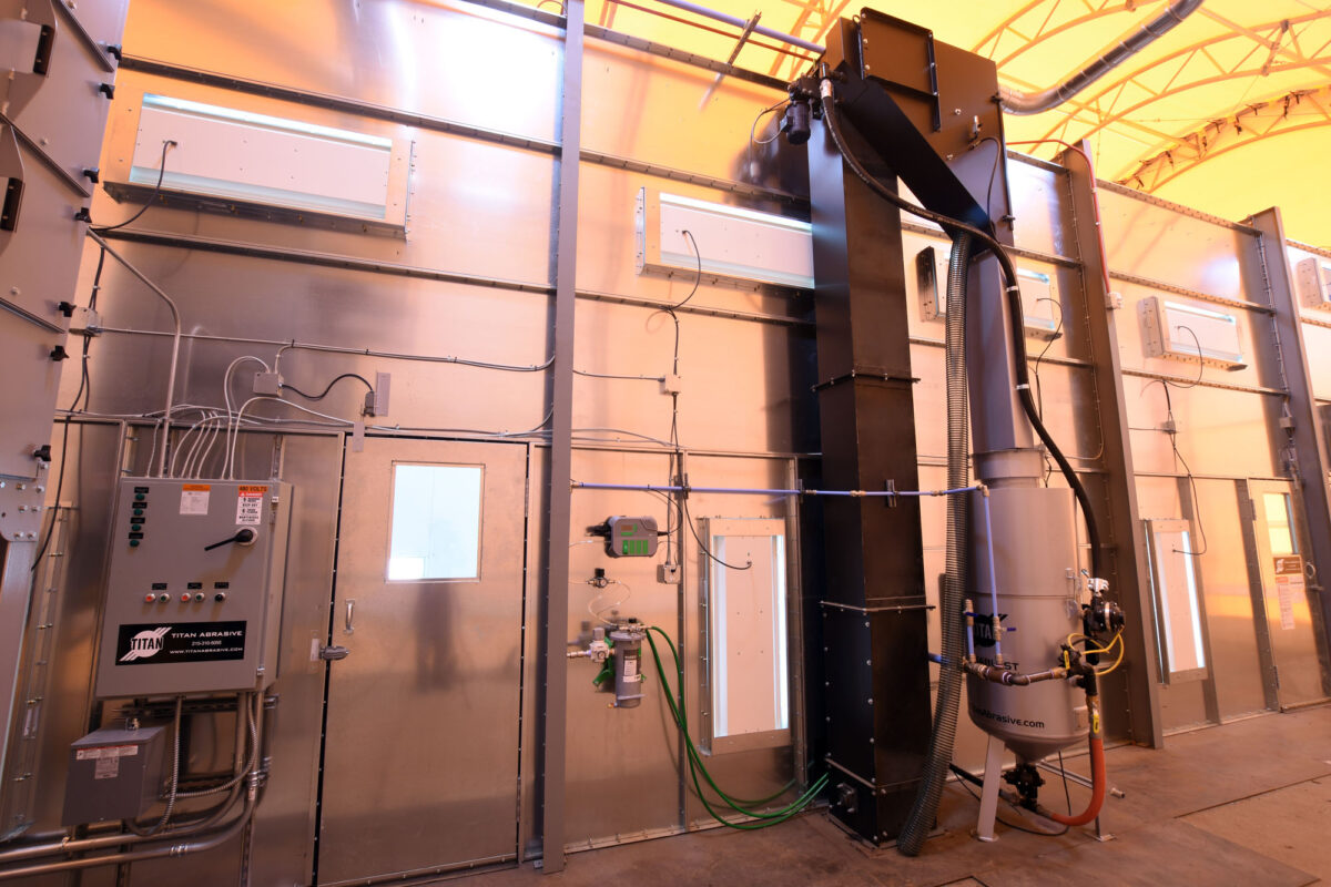 Custom-engineered Titan Abrasive blast room with mechanical reclaim system
